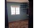 Bedroom with built-in shelves, a window, and teal walls at 6760 Fallona Ave, Las Vegas, NV 89156