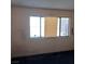 Bedroom featuring carpet, standard windows with blinds and neutral wall color at 6760 Fallona Ave, Las Vegas, NV 89156