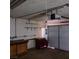 Garage featuring a white sectional door with a workbench and open storage space at 6760 Fallona Ave, Las Vegas, NV 89156