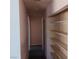 Hallway featuring open shelves and neutral-colored walls at 6760 Fallona Ave, Las Vegas, NV 89156