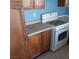 This kitchen features wooden cabinets, laminate countertops, and a gas range at 6760 Fallona Ave, Las Vegas, NV 89156