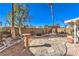Beautiful backyard featuring mature landscaping, a shade structure and stone design at 7267 Sequoia Springs Dr, Las Vegas, NV 89147