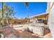 Relaxing backyard with privacy wall, stone design, hot tub, shaded patio, and lush landscaping at 7267 Sequoia Springs Dr, Las Vegas, NV 89147