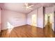 Spacious bedroom featuring wood floors, ceiling fan, and ensuite bath access at 7267 Sequoia Springs Dr, Las Vegas, NV 89147