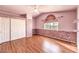 Bright bedroom featuring laminate wood floors and sliding closet doors at 7267 Sequoia Springs Dr, Las Vegas, NV 89147