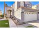 Charming home featuring a well-maintained lawn and a two-car garage with decorative windows at 7267 Sequoia Springs Dr, Las Vegas, NV 89147