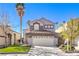 Charming two-story home featuring a well-maintained lawn and a two-car garage in a residential neighborhood at 7267 Sequoia Springs Dr, Las Vegas, NV 89147