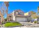 Charming two-story home featuring a well-maintained lawn and a two-car garage in a residential neighborhood at 7267 Sequoia Springs Dr, Las Vegas, NV 89147