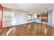 Open living room with wood floors, lots of natural light and attached kitchen area at 7267 Sequoia Springs Dr, Las Vegas, NV 89147