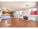 Open-concept living space with wood flooring, a fireplace, and a view of the kitchen area at 7267 Sequoia Springs Dr, Las Vegas, NV 89147