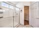 Glass shower with white tiling and a glimpse of the walk-in closet at 7267 Sequoia Springs Dr, Las Vegas, NV 89147