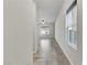 Hallway featuring tile floors, neutral paint, and natural light from nearby windows at 7370 Glowing Point St, North Las Vegas, NV 89084