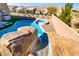 Backyard pool and spa with rock waterfall feature and slide for entertainment at 7370 Glowing Point St, North Las Vegas, NV 89084