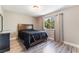 Cozy bedroom with window views, neutral walls, and modern floors at 7817 Aplin Ave, Las Vegas, NV 89145