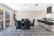 Dining area with modern table, chairs, and decorative tile flooring, adjacent to outdoor patio at 7817 Aplin Ave, Las Vegas, NV 89145