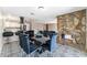 Open-concept dining room with stone fireplace, adjacent to kitchen and living areas at 7817 Aplin Ave, Las Vegas, NV 89145