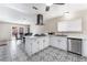 Bright kitchen with modern appliances, white cabinets, and decorative tile flooring adjacent to a dining area at 7817 Aplin Ave, Las Vegas, NV 89145