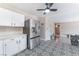 Contemporary kitchen featuring stainless steel refrigerator, stylish tile flooring, and white cabinetry at 7817 Aplin Ave, Las Vegas, NV 89145