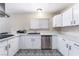 Well-equipped kitchen with white cabinetry, stainless steel appliances, and eye-catching patterned flooring at 7817 Aplin Ave, Las Vegas, NV 89145