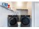 Laundry area featuring two front loading washer and dryer units at 7817 Aplin Ave, Las Vegas, NV 89145