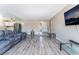 Expansive living room featuring modern flooring, comfortable seating, and a seamless transition to the kitchen area at 7817 Aplin Ave, Las Vegas, NV 89145