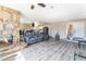Inviting living area with stone fireplace, modern floors, and seamless integration with dining and kitchen spaces at 7817 Aplin Ave, Las Vegas, NV 89145