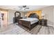 The spacious primary bedroom is adorned with dark wood furniture, a ceiling fan, and ensuite access at 7817 Aplin Ave, Las Vegas, NV 89145