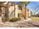 Charming condo exterior featuring well-maintained landscaping, mature trees, and a warm color palette at 7885 W Flamingo Rd # 1131, Las Vegas, NV 89147