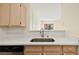 Bright kitchen featuring light wood cabinets and a stainless steel sink beneath a garden window at 7885 W Flamingo Rd # 1131, Las Vegas, NV 89147