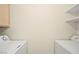 Functional laundry room with washer and dryer hookups and shelving at 7885 W Flamingo Rd # 1131, Las Vegas, NV 89147