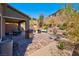 Spacious backyard with a covered patio, outdoor kitchen, dining area, seating, and meticulous landscaping at 8 Via Dolcetto, Henderson, NV 89011