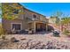 Expansive backyard patio with multiple seating areas, a built-in grill, and a beautifully landscaped yard at 8 Via Dolcetto, Henderson, NV 89011