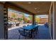 Charming covered patio with a dining table and chairs, perfect for outdoor entertaining and relaxation at 8 Via Dolcetto, Henderson, NV 89011