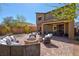 Lush backyard featuring a cozy seating area with a fire pit, a dining set, and a built-in barbecue at 8 Via Dolcetto, Henderson, NV 89011