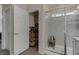Bathroom with tiled shower, glass door, wooden bench, and closet at 8 Via Dolcetto, Henderson, NV 89011