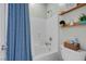 Clean bathroom featuring a shower with blue curtains, a toilet, and decorative shelves at 8 Via Dolcetto, Henderson, NV 89011