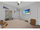 Bright bedroom with a ceiling fan, mounted TV, and a dedicated workspace at 8 Via Dolcetto, Henderson, NV 89011