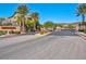 Community entrance gate featuring neatly landscaped bushes and trees at 8 Via Dolcetto, Henderson, NV 89011