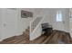 Welcoming entryway featuring wood floors, white trim, stairway, and a bench for convenience at 8 Via Dolcetto, Henderson, NV 89011