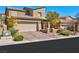 Charming two-story stucco home featuring a paved driveway and an attached two-car garage at 8 Via Dolcetto, Henderson, NV 89011