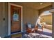 Inviting covered porch with brick flooring and seating area at 8 Via Dolcetto, Henderson, NV 89011