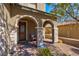 Inviting covered porch with brick flooring and stone columns at 8 Via Dolcetto, Henderson, NV 89011