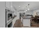 Modern kitchen features a large island, stainless steel appliances, and sleek white cabinetry at 8 Via Dolcetto, Henderson, NV 89011
