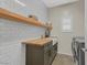 Convenient laundry room featuring wooden countertops, a sink, and ample shelving for storage at 8 Via Dolcetto, Henderson, NV 89011