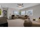 Comfortable living room with sectional sofa, ceiling fan and natural light at 8 Via Dolcetto, Henderson, NV 89011