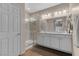 The well-lit bathroom features a double vanity and a walk-in shower at 8 Via Dolcetto, Henderson, NV 89011