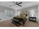 Bedroom features a large bed, neutral décor, and lots of natural light from windows at 8 Via Dolcetto, Henderson, NV 89011