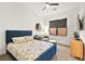 Cozy bedroom with a blue bed frame, seating area, and modern ceiling fan at 803 Bolide St, Las Vegas, NV 89138