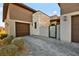 Contemporary home with a paved driveway, desert landscaping, and stone accents at 803 Bolide St, Las Vegas, NV 89138