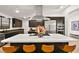 Modern kitchen featuring an island with seating and a sleek stainless steel range hood at 803 Bolide St, Las Vegas, NV 89138